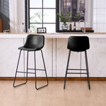 Set of 2 black counter and bar height stools styled at a kitchen island with modern decor