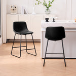 Set of 2 black counter and bar height stools styled at a kitchen island with modern decor
