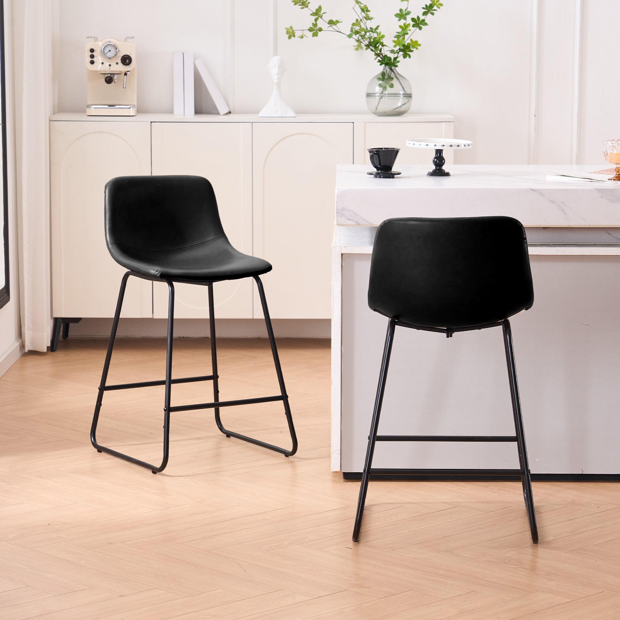 Set of 2 black counter and bar height stools styled at a kitchen island with modern decor