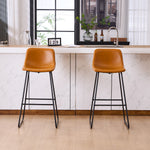 Set of 2 brown counter and bar height stools styled at a kitchen island with modern decor