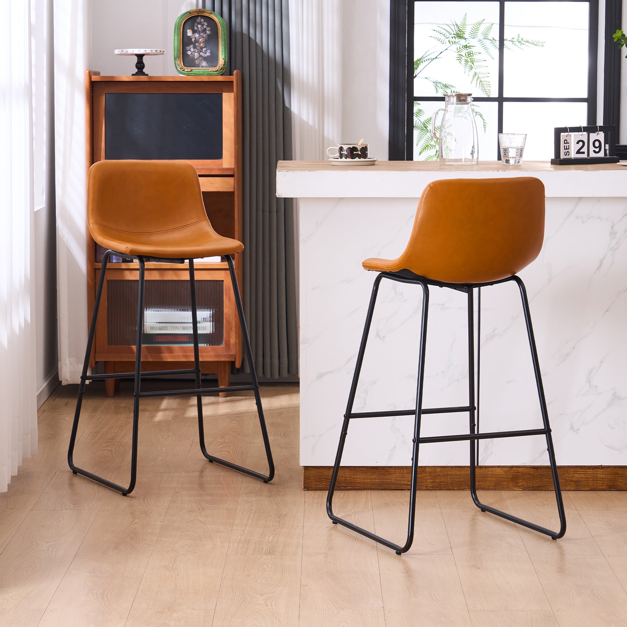 Set of 2 brown counter height and bar height stools with padded seats and metal legs, modern minimalist design