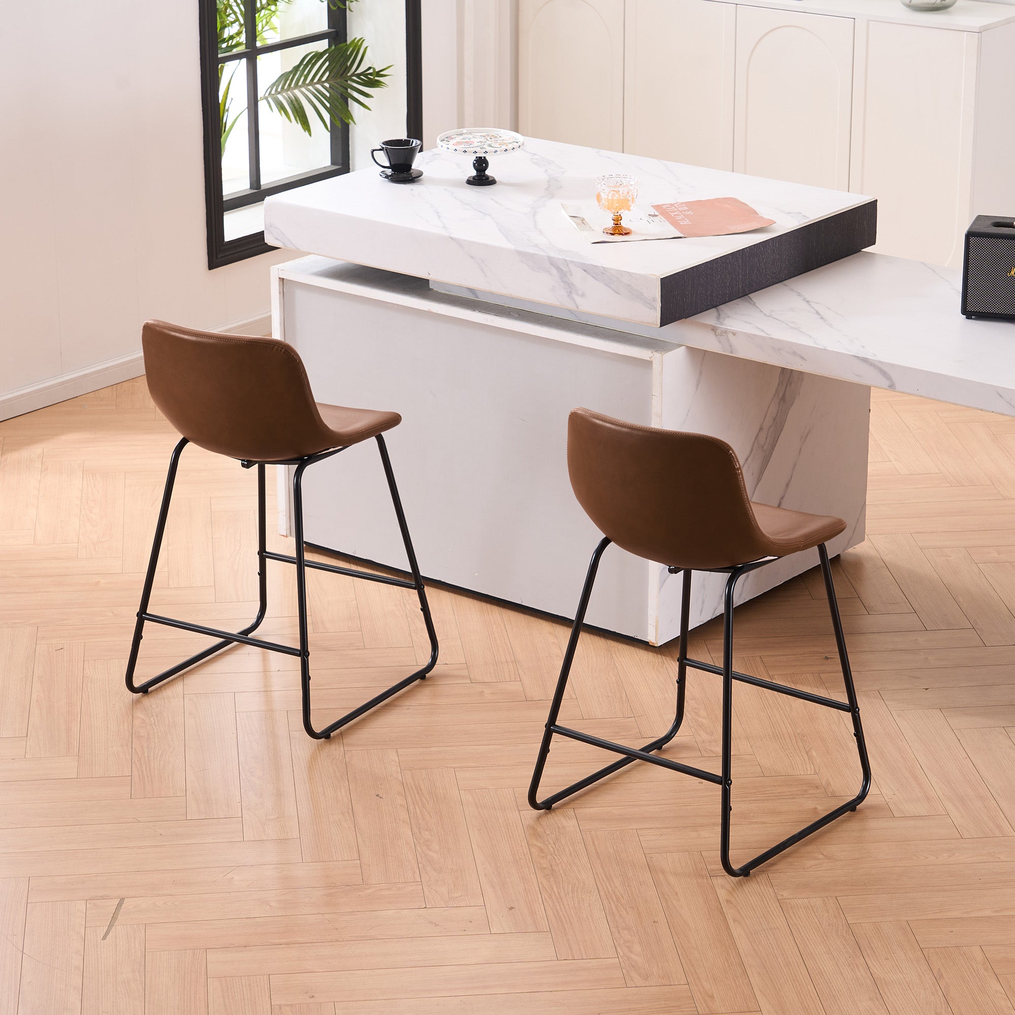 Set of 2 brown counter and bar height stools styled at a kitchen island with modern decor