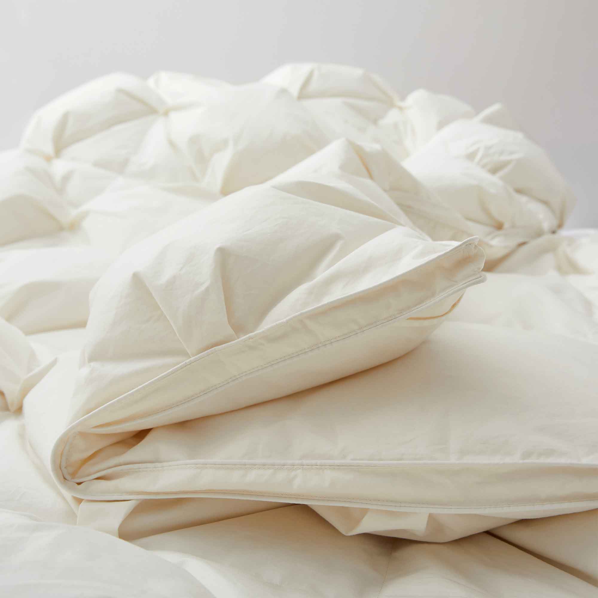 The down comforter is brushed in the pearly tones of off-white. Bring sophisticated elegance to your bedroom decor with this off-white bed comforter.