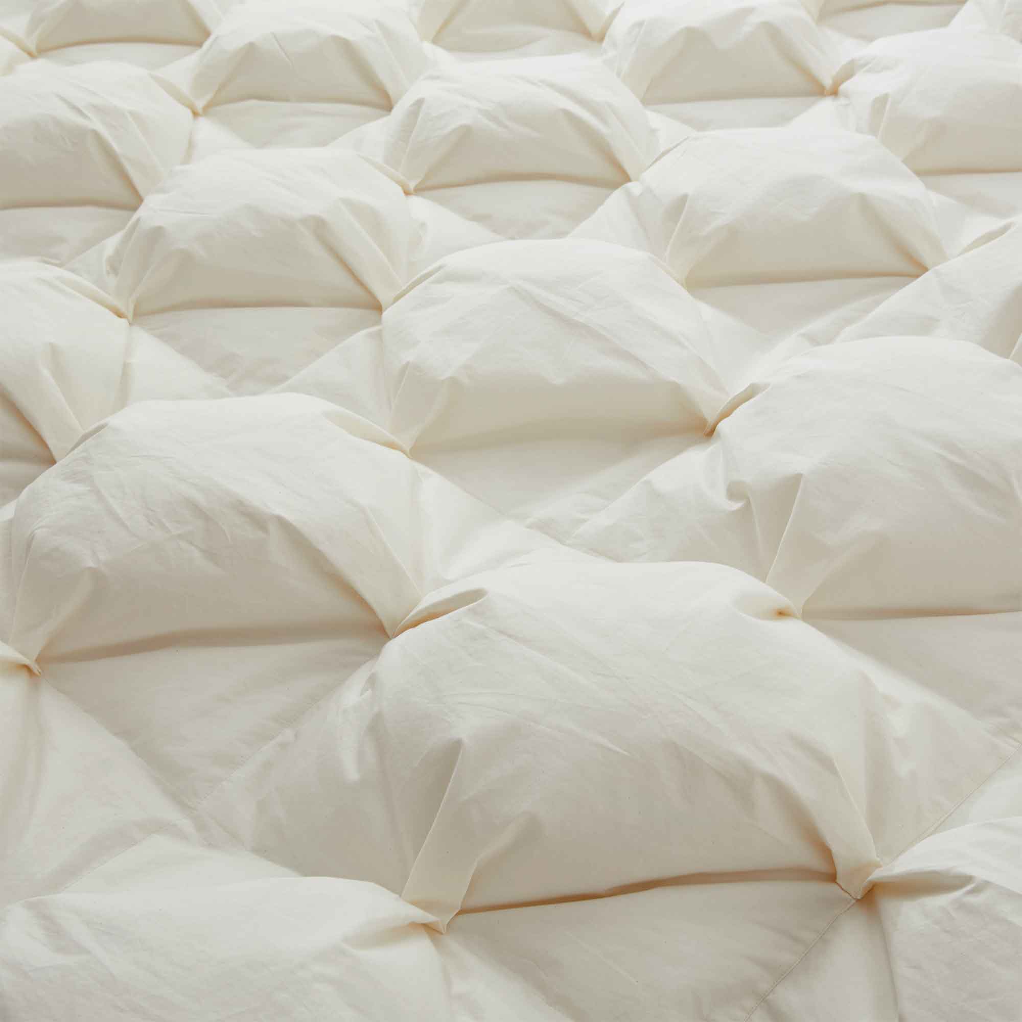 The down comforter is brushed in the pearly tones of off-white. Bring sophisticated elegance to your bedroom decor with this off-white bed comforter.