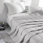 Lightweight light gray down blanket with 100% cotton cover and box quilting, featuring contrast piping and breathable comfort for year-round use
