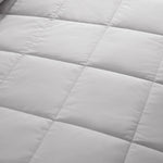 Lightweight light gray down blanket with 100% cotton cover and box quilting, featuring contrast piping and breathable comfort for year-round use