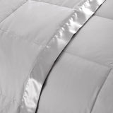 Lightweight light gray down blanket with 100% cotton cover and box quilting, featuring contrast piping and breathable comfort for year-round use