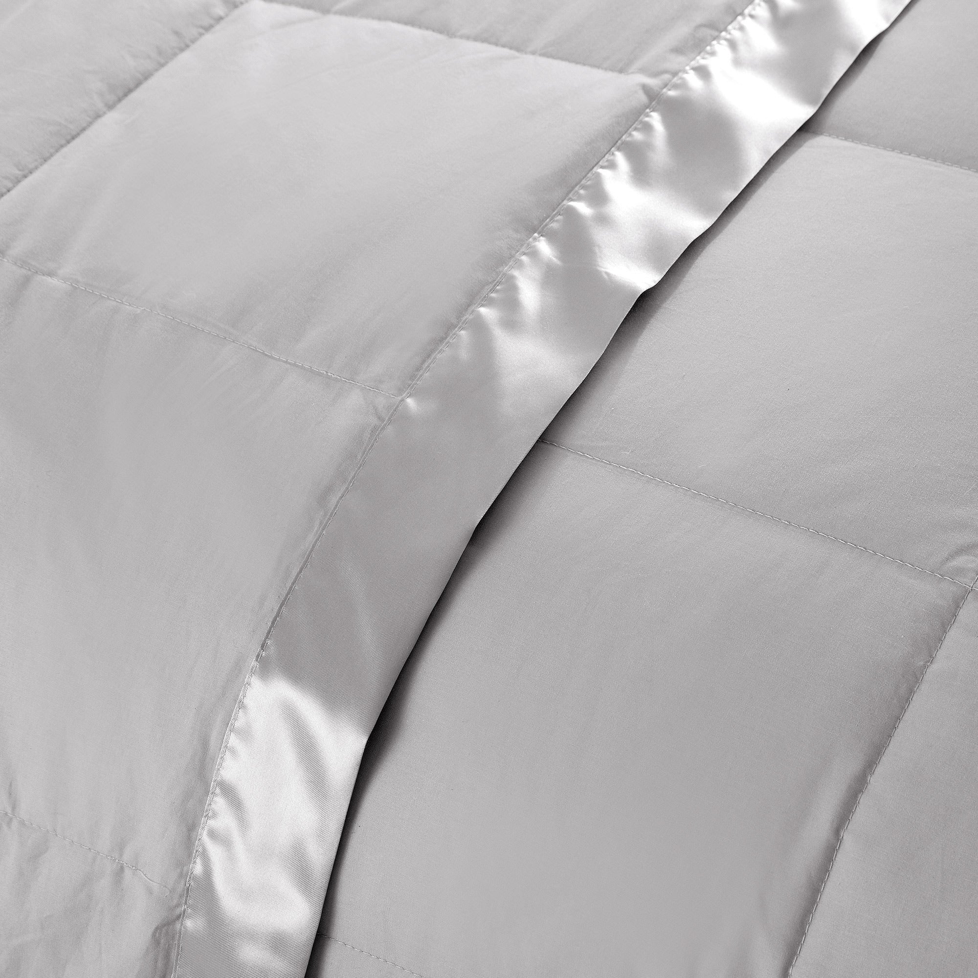 Lightweight light gray down blanket with 100% cotton cover and box quilting, featuring contrast piping and breathable comfort for year-round use