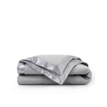 Lightweight light gray down blanket with 100% cotton cover and box quilting, featuring contrast piping and breathable comfort for year-round use
