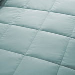 Lightweight winter sky down blanket with 100% cotton cover and box quilting, featuring contrast piping and breathable comfort for year-round use