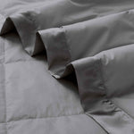 Lightweight dark gray down blanket with 100% cotton cover and box quilting, featuring contrast piping and breathable comfort for year-round use