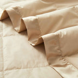 Lightweight pearled ivory down blanket with 100% cotton cover and box quilting, featuring contrast piping and breathable comfort for year-round use