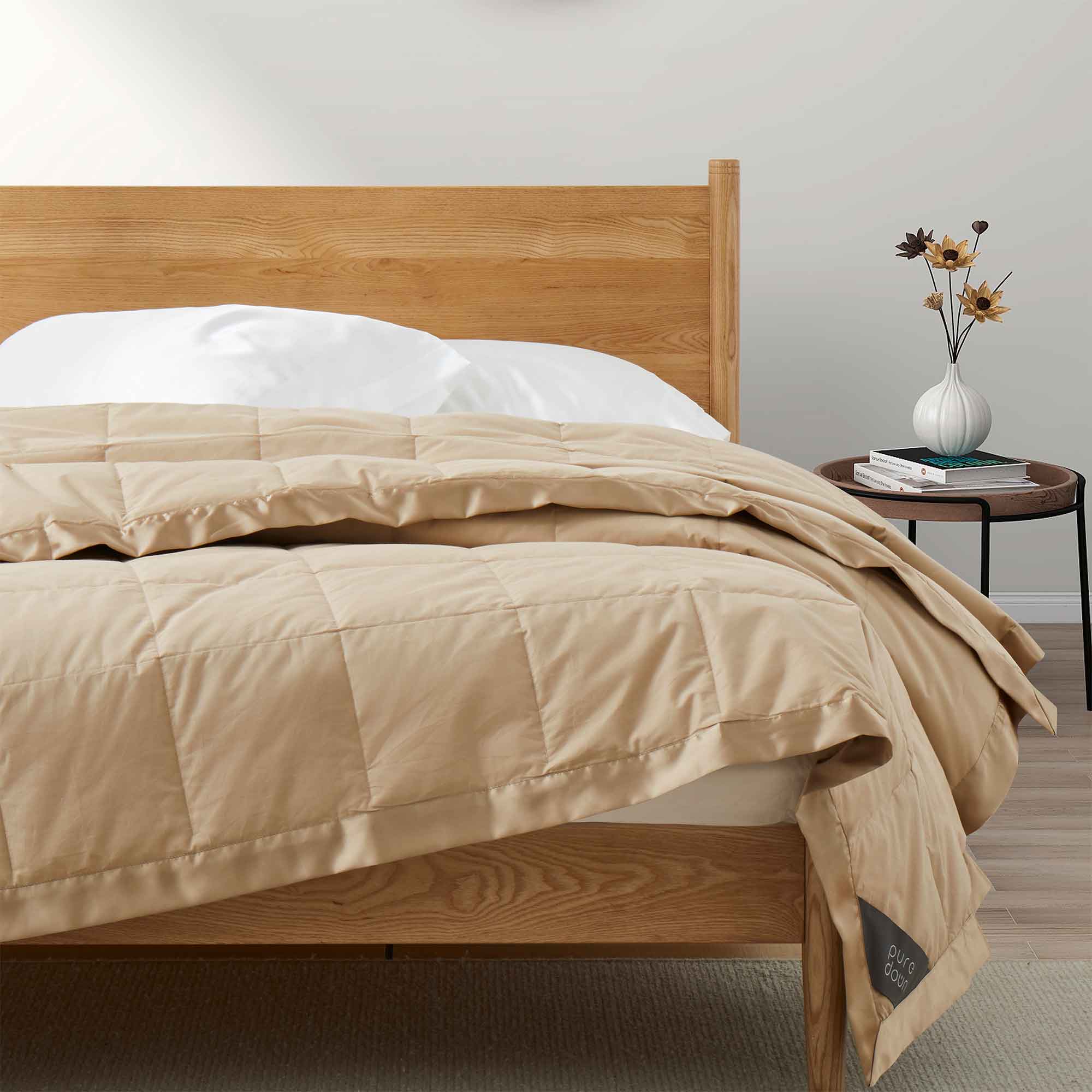 Lightweight pearled ivory down blanket with 100% cotton cover and box quilting, featuring contrast piping and breathable comfort for year-round use