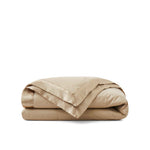 Lightweight pearled ivory down blanket with 100% cotton cover and box quilting, featuring contrast piping and breathable comfort for year-round use