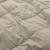 Lightweight vintaged khaki down blanket with 100% cotton cover and box quilting, featuring contrast piping and breathable comfort for year-round use
