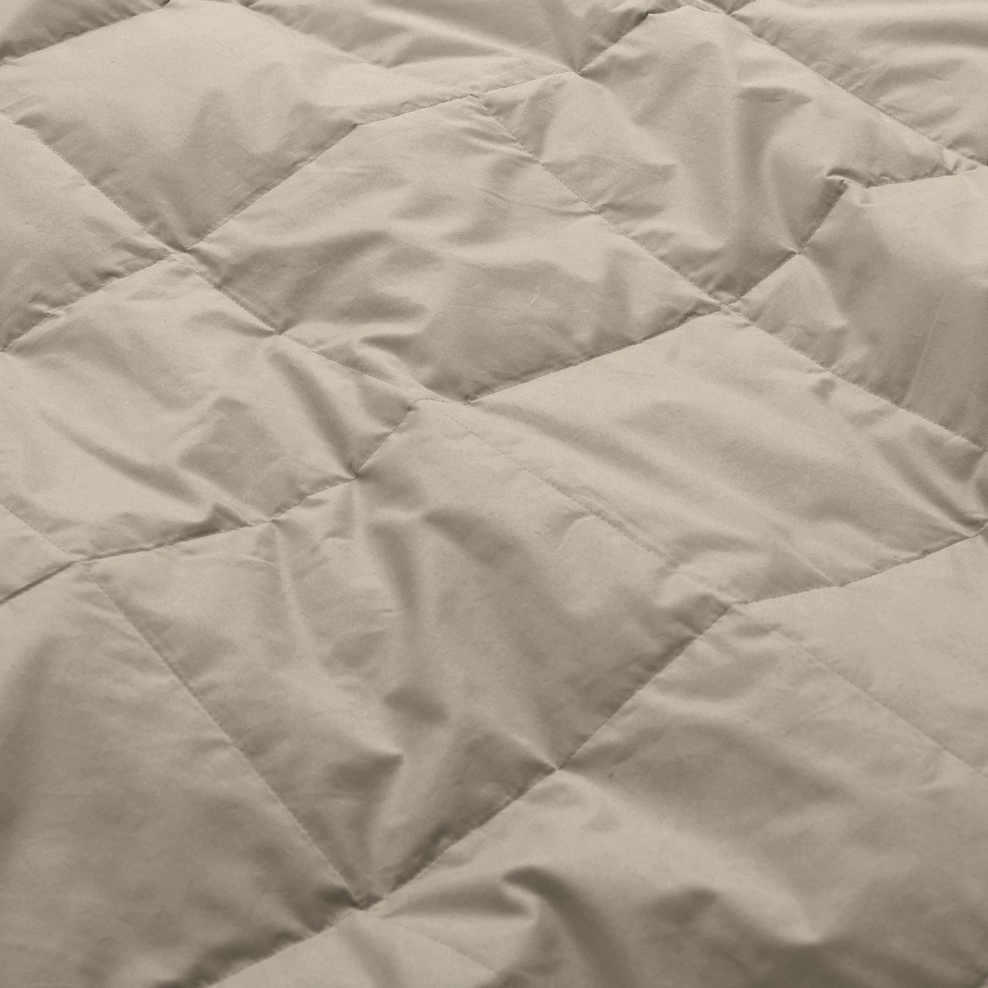 Lightweight vintaged khaki down blanket with 100% cotton cover and box quilting, featuring contrast piping and breathable comfort for year-round use