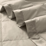 Lightweight vintaged khaki down blanket with 100% cotton cover and box quilting, featuring contrast piping and breathable comfort for year-round use