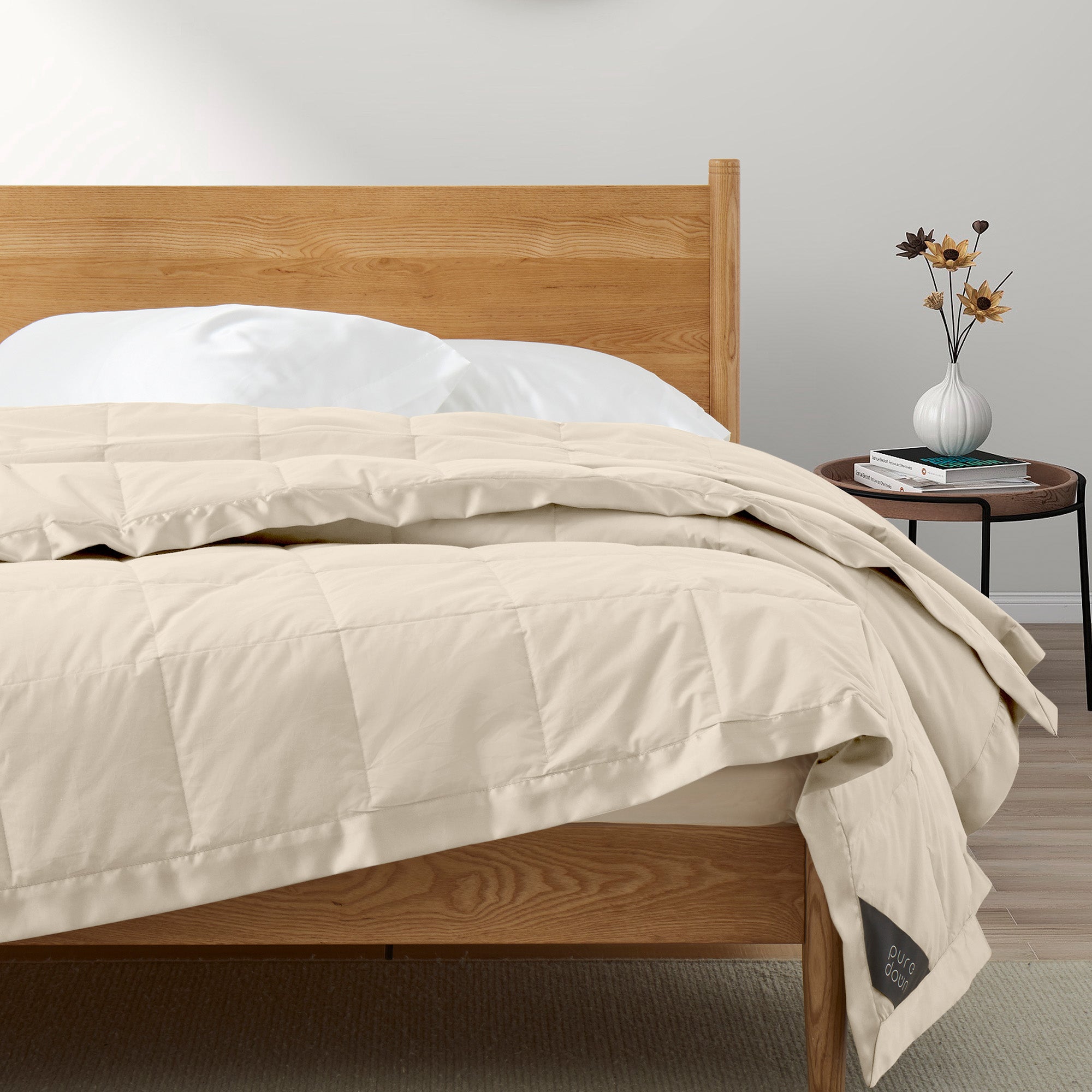 Lightweight caramel beige down blanket with 100% cotton cover and box quilting, featuring contrast piping and breathable comfort for year-round use
