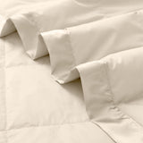 Lightweight caramel beige down blanket with 100% cotton cover and box quilting, featuring contrast piping and breathable comfort for year-round use