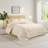 Lightweight caramel beige down blanket with 100% cotton cover and box quilting, featuring contrast piping and breathable comfort for year-round use