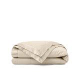 Lightweight caramel beige down blanket with 100% cotton cover and box quilting, featuring contrast piping and breathable comfort for year-round use