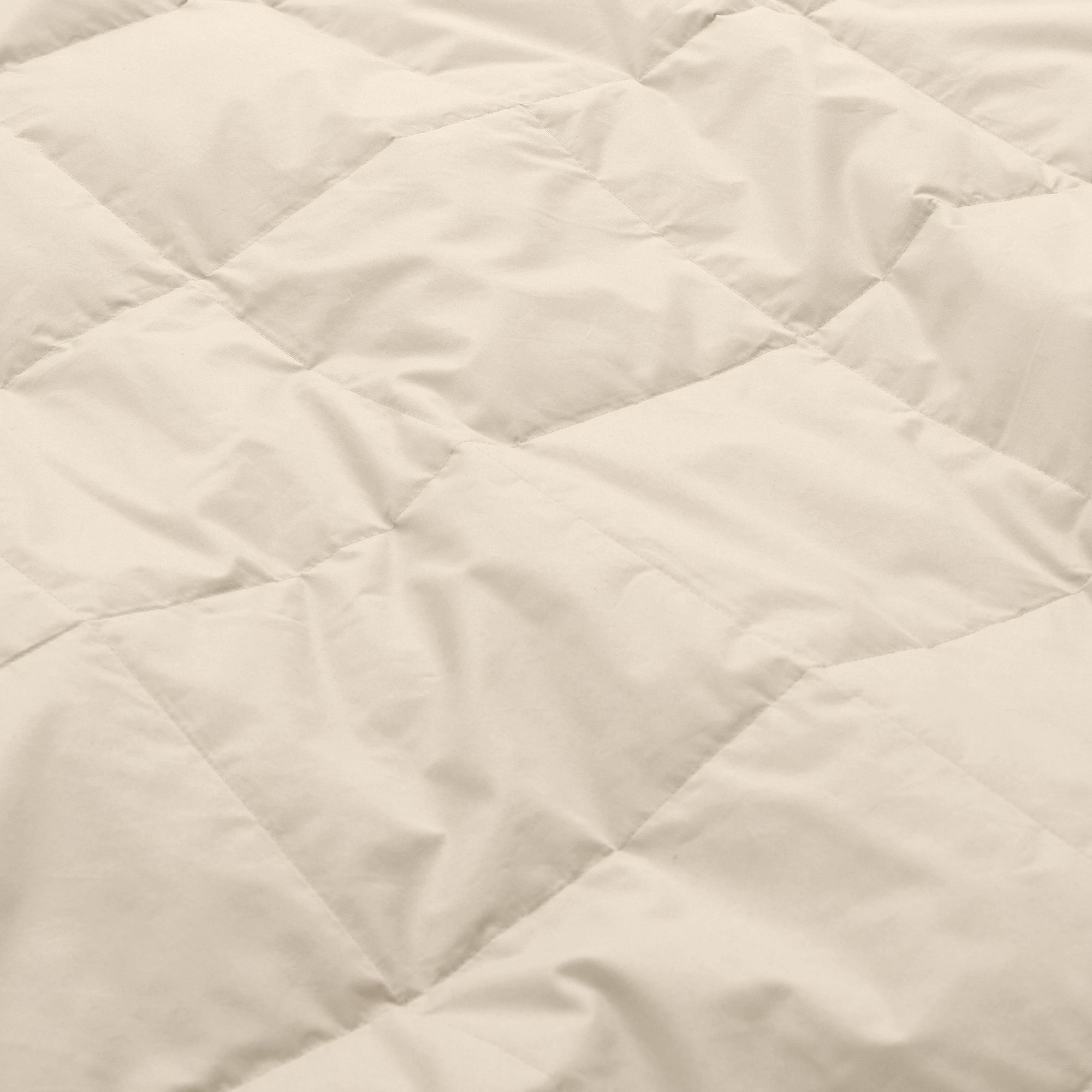 Lightweight caramel beige down blanket with 100% cotton cover and box quilting, featuring contrast piping and breathable comfort for year-round use