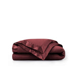 Lightweight wine red down blanket with 100% cotton cover and box quilting, featuring contrast piping and breathable comfort for year-round use