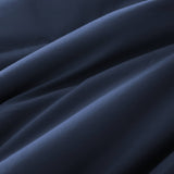 Lightweight navy down blanket with 100% cotton cover and box quilting, featuring contrast piping and breathable comfort for year-round use