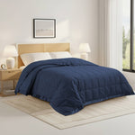 Lightweight navy down blanket with 100% cotton cover and box quilting, featuring contrast piping and breathable comfort for year-round use