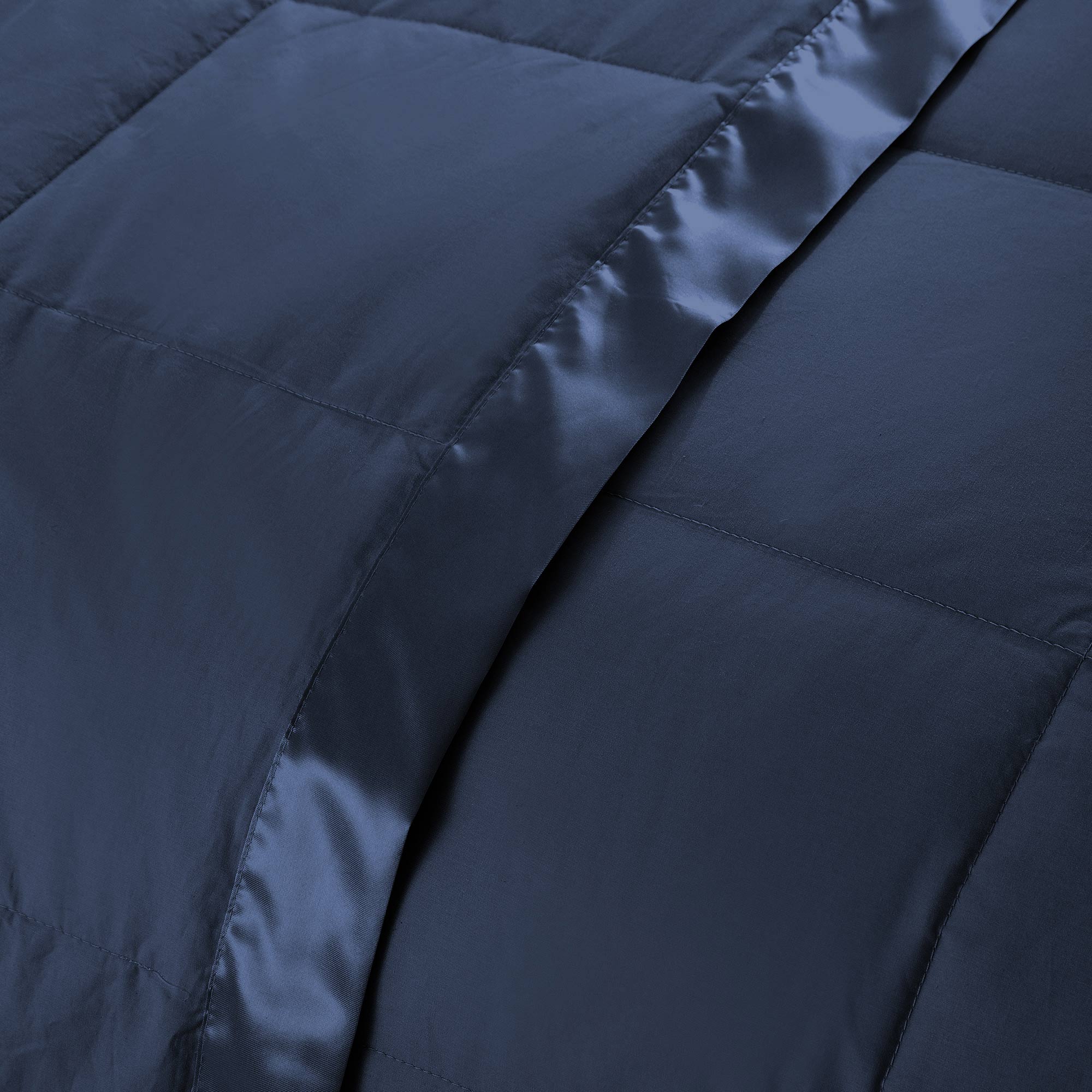 Lightweight navy down blanket with 100% cotton cover and box quilting, featuring contrast piping and breathable comfort for year-round use