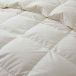 Crafted with a 100% organic cotton shell and filled with 90% natural white down, this comforter offers superior warmth and breathability. Its 800 fill power ensures a lightweight yet insulating sleep experience. Designed for year-round comfort, it features baffle box construction to maintain even fill distribution. Available in all-season and extra warm options, this comforter combines eco-friendly materials with luxurious softness for a restful night's sleep.