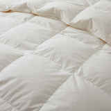 Crafted with a 100% organic cotton shell and filled with 90% natural white down, this comforter offers superior warmth and breathability. Its 800 fill power ensures a lightweight yet insulating sleep experience. Designed for year-round comfort, it features baffle box construction to maintain even fill distribution. Available in all-season and extra warm options, this comforter combines eco-friendly materials with luxurious softness for a restful night's sleep.