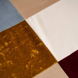 Detailed view of jacquard patchwork fabric with multicolor panels on accent chair upholstery