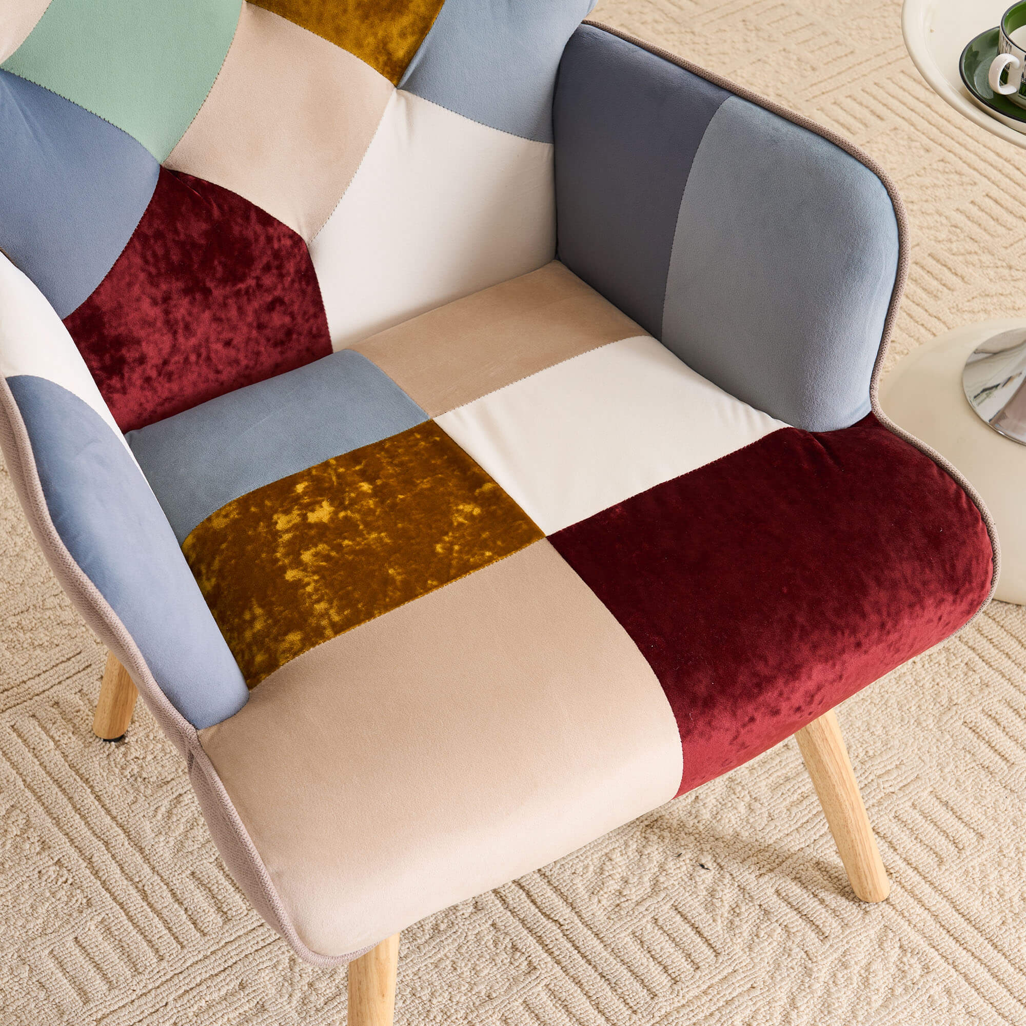 Detailed view of jacquard patchwork fabric with multicolor panels on accent chair upholstery