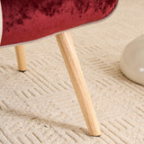Close-up of solid wood chair leg with natural finish on patchwork accent armchair