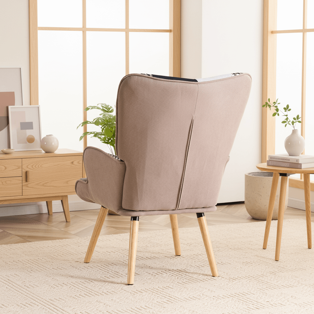 Back view of gray and black patchwork accent armchair showing smooth fabric back and solid wood legs
