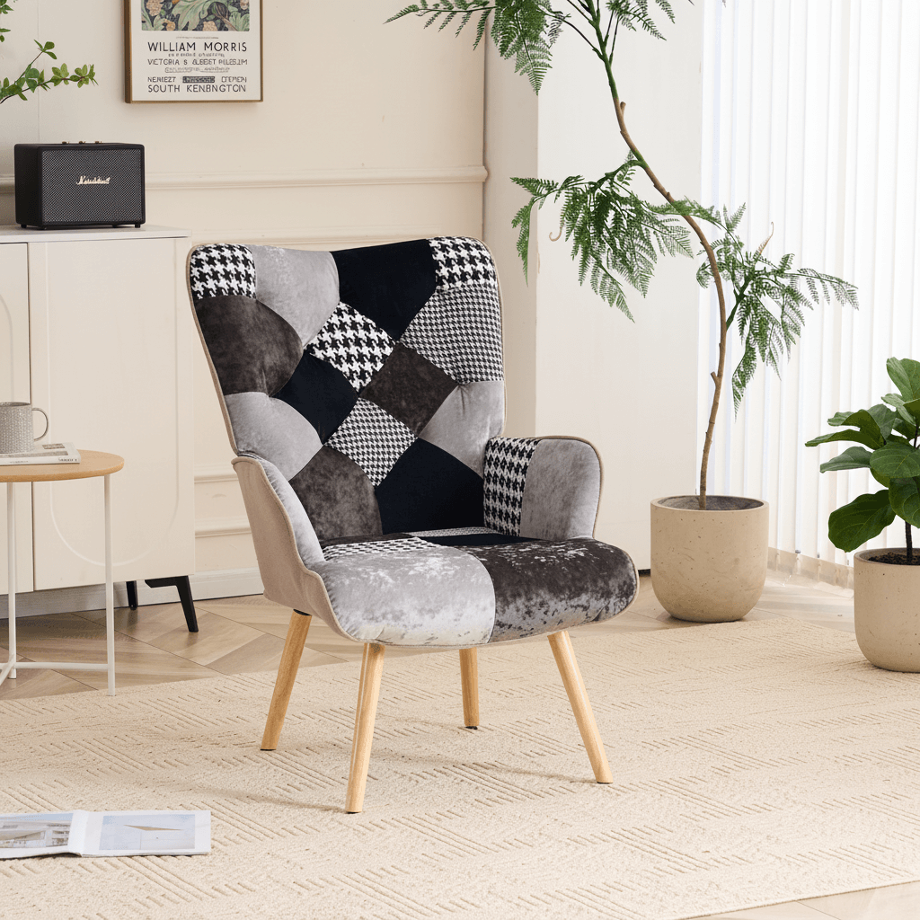 Gray and black patchwork accent armchair styled in a modern living room with wooden legs