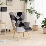 Gray and black patchwork accent armchair styled in a modern living room with wooden legs