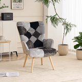 Gray and black patchwork accent armchair styled in a modern living room with wooden legs