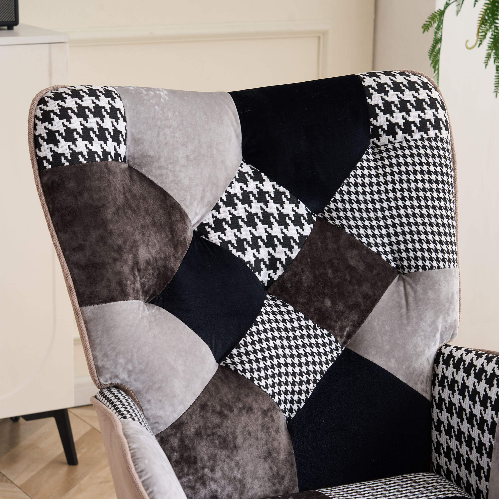 Close-up of gray and black jacquard patchwork upholstery on the tufted backrest of the accent chair