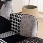 Close-up of padded armrest with gray and black patchwork fabric upholstery on accent chair