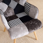 Detailed view of cushioned seat with gray and black patchwork upholstery on accent armchair