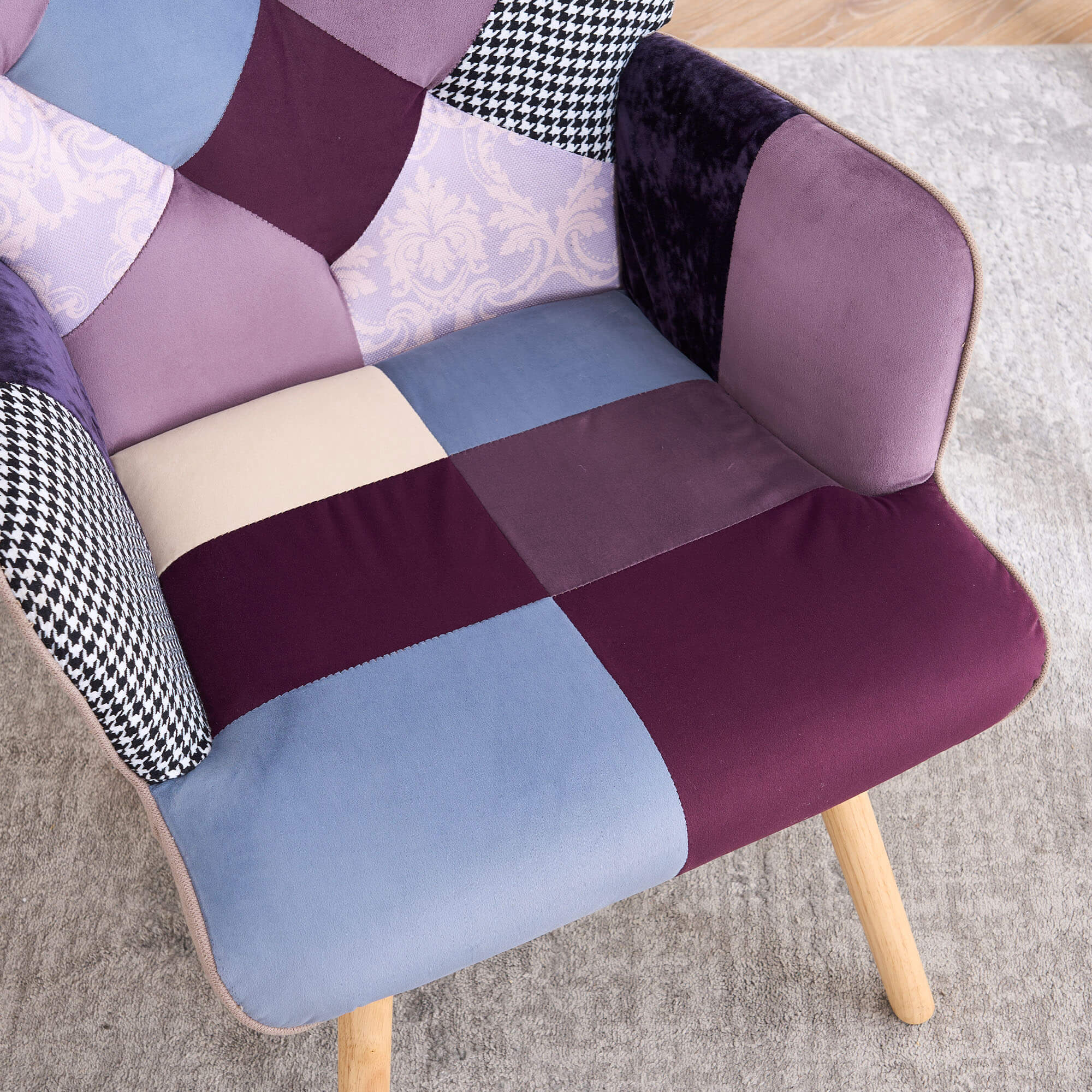 Purple and blue patchwork accent armchair showing padded armrest and cushioned seat