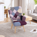 Purple and blue patchwork accent chair with tufted back and cushioned seat, styled in a bright living space