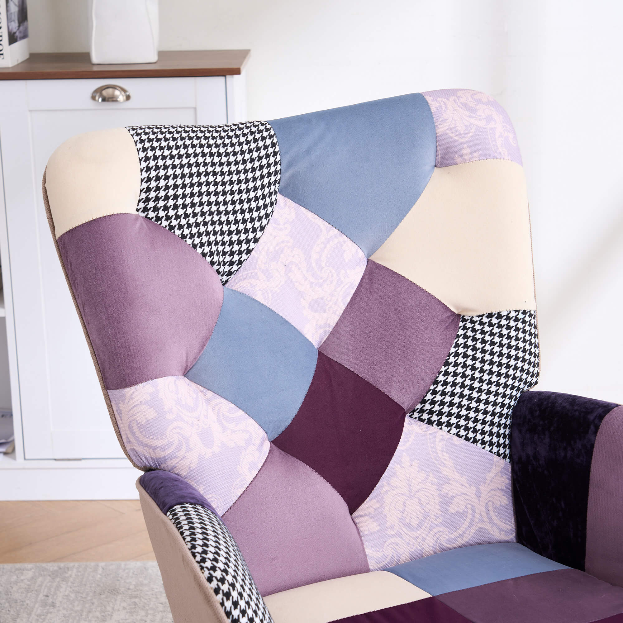 Close-up of purple and blue jacquard patchwork upholstery on the tufted backrest of the accent chair