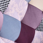 Detailed view of purple and blue jacquard patchwork fabric panels on accent chair upholstery