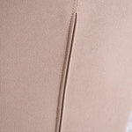 Close-up of smooth solid-color fabric on the back of the patchwork accent armchair