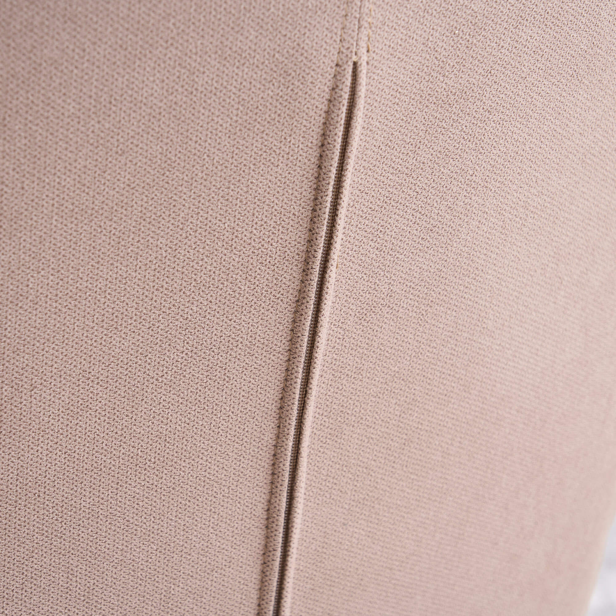 Close-up of smooth solid-color fabric on the back of the patchwork accent armchair