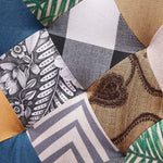 Detailed view of jacquard patchwork upholstery on the tufted backrest of the accent chair
